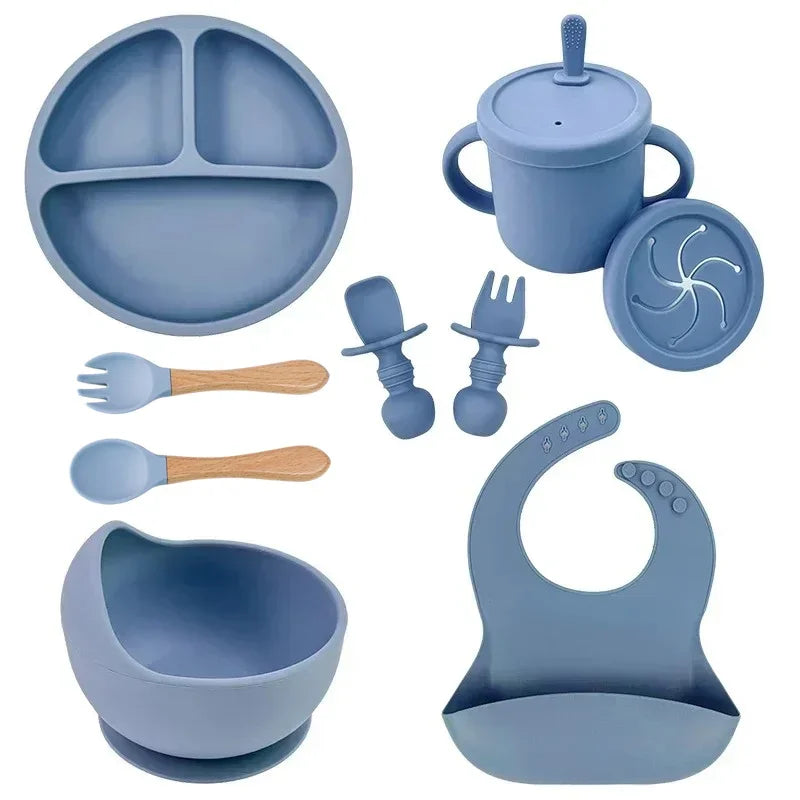 Blue silicone baby feeding set with plate, bowl, bib, utensils, training cup, and snack lid