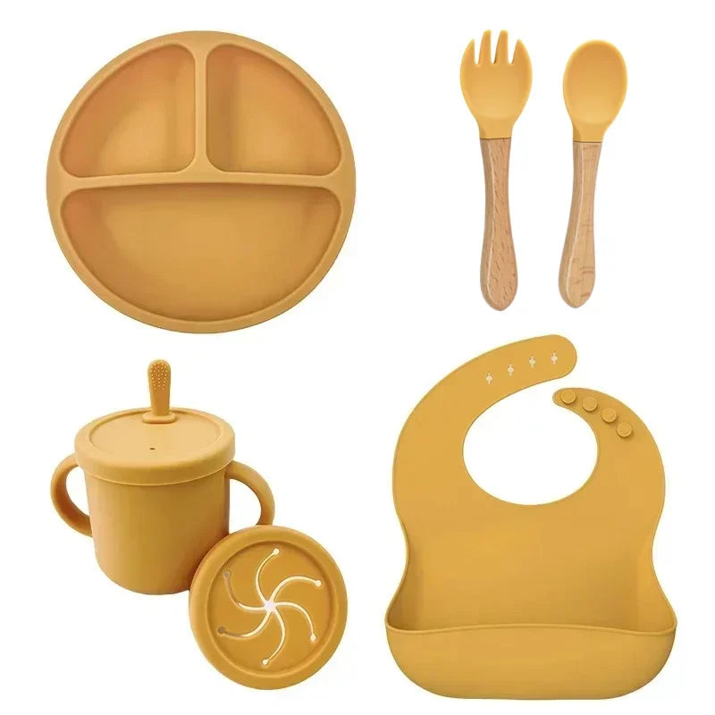 Yellow silicone baby feeding set with bib, divided plate, sippy cup and utensils