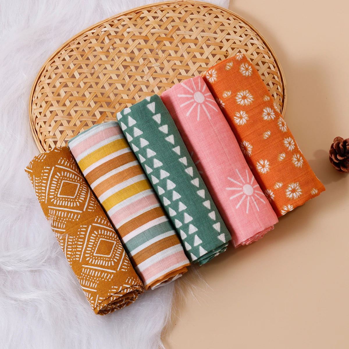 Colorful rolled muslin baby swaddle blankets with geometric and floral patterns